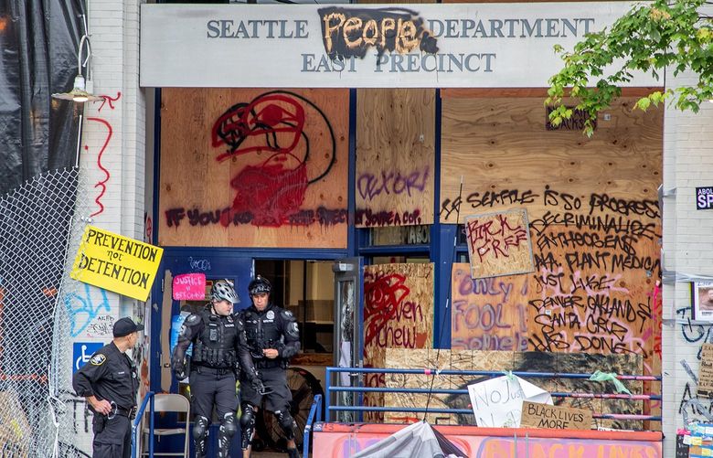 Seattle Police take over and re-enter the East Precinct early Wednesday morning after the area around the police station was occupied by protestors for the last month. 
 
Photographed on July 1, 2020.  214399