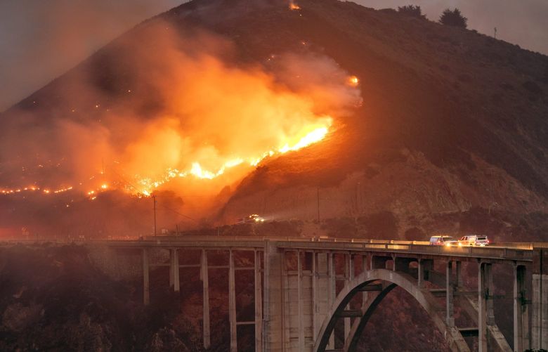 The Colorado Fire burns down toward the Bixby Bridge in Big Sur, Calif., early Saturday morning, Jan. 22, 2022. (Karl Mondon/Bay Area News Group via AP) CAJOS101 CAJOS101