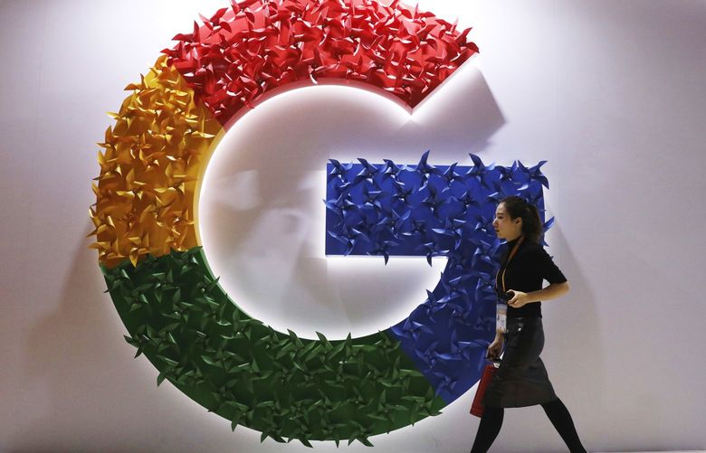 Alphabet is the parent company of Google.  A woman walks past the logo for Google at the China International Import Expo in Shanghai, Nov. 5, 2018. (AP Photo/Ng Han Guan, File) 