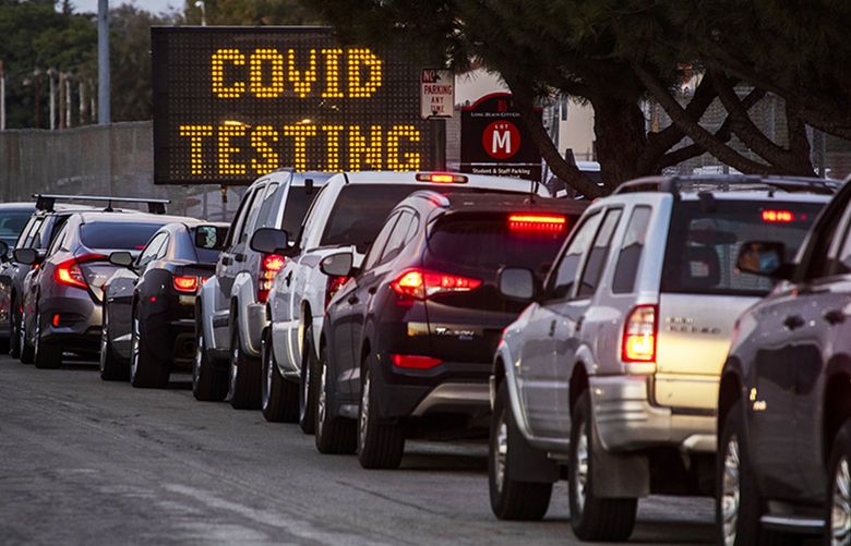 Motorists line up to take COVID-19 tests at Long Beach City College-Veterans Memorial Stadium on Jan. 5, 2022, in Long Beach, California. (Allen J. Schaben/Los Angeles Times/TNS) 37130201W 37130201W