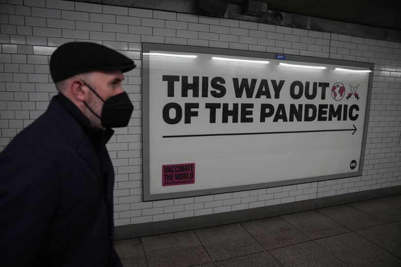 A man walks past a health campaign poster in an underpass leading to the Westminster underground train station in London on Thursday. (Matt Dunham / The Associated Press)