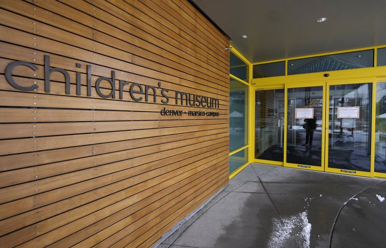 Signs hang on the shuttered doors of the Children’s Museum of Denver at Marsico Campus Thursday, Jan. 27, 2022, in Denver. The popular museum temporarily closed on Wednesday because of escalating harassment of staff by adult visitors angry over a city-ordered mandate requiring anyone age 2 and older to wear a mask in indoor public spaces. The museum will remain closed until Friday, Feb. 4. (AP Photo/David Zalubowski) CODZ110 CODZ110