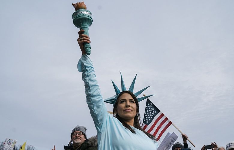 A woman dressed as the Statue of Liberty poses during a Defeat the Mandates Rally, on National Mall on Sunday, Jan. 23, 2022, in Washington, DC. Demonstrators are protesting mask and COVID-19 vaccination mandates. (Kent Nishimura/Los Angeles Times/TNS) 38698549W 38698549W