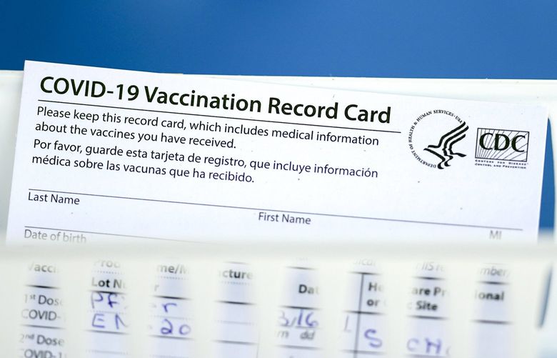 A vaccination record card is shown during a COVID-19 vaccination drive for Spring Branch Independent School District education workers Tuesday, March 16, 2021, in Houston. School employees who registered were given the Pfizer vaccine.(AP Photo/David J. Phillip) TXDP102