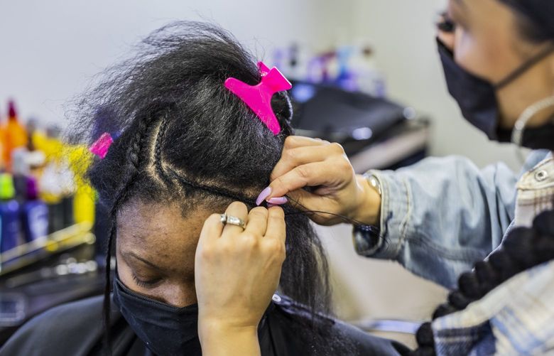 Stylist Lashawn Jenkins braids customer Dorianne Salmon at Noir in Bellevue on Jan. 25, 2022. Jenkins has been here for 20 plus years. Most of the styles I do are sew-in weaves, natural flat irons and if they want an updo,” said Jenkins.