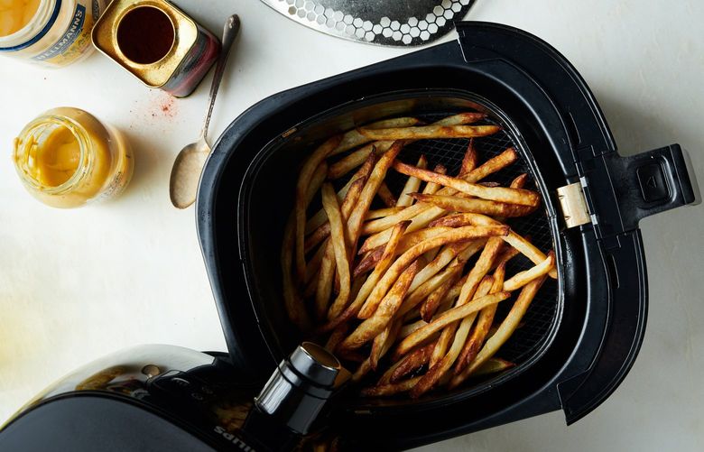 FILE – A batch of French fries in an air fryer in New York in October 2018. Though air fryers are sold as a way to make foods crunchy without deep-frying, home cooks have put them to countless other uses – and fed a billion-dollar business. Food styled by Simon Andrews. (David Malosh/The New York Times)