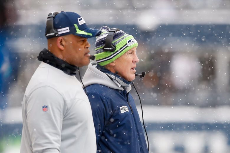 Seahawks head coach Pete Carroll, right, and defensive coordinator Ken Norton Jr. watch from the sidelines during the first quarter Sunday, Dec. 26, 2021, in Seattle. (Jennifer Buchanan / The Seattle Times)