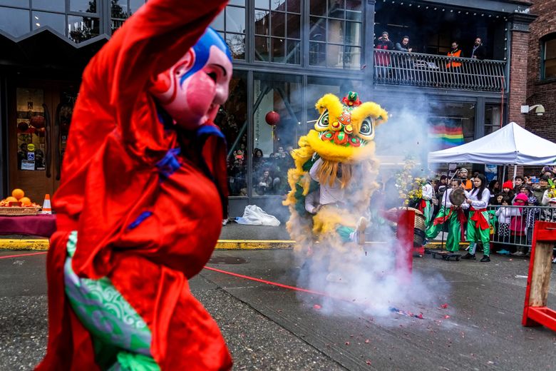 The LQ Lion Dance Team dances around a string of lit firecrackers on South King Street during a street performance in 2020. (Alan Alabastro / Alabastro Photography)