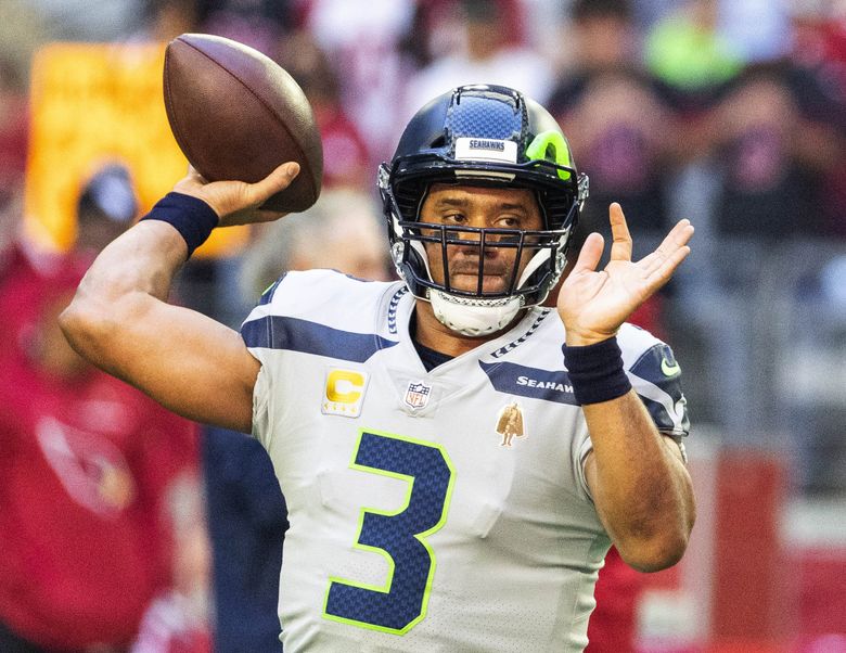 Russell Wilson warms up for the regular-season finale in Glendale, Arizona, last Sunday. (Dean Rutz / The Seattle Times)