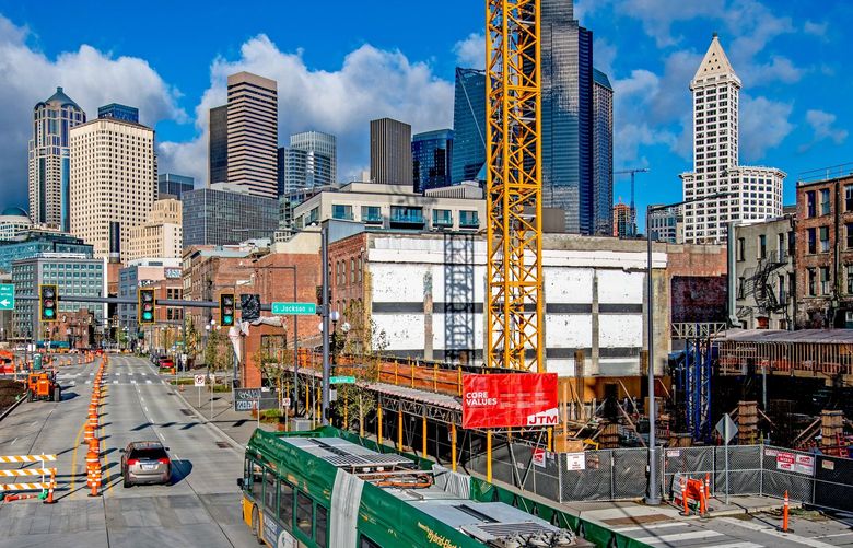 NOW: Looking north from South Jackson Street and Alaskan Way on a rare sunny day in mid-December 2021, a viaduct-free waterfront bustles with construction amid the long process of rebuilding a divided city. Credit: Jean Sherrard