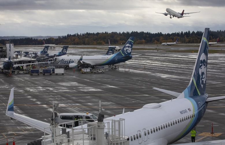 Travelers in the Alaska Lounge in the new N Concourse at SEA (Seattle-Tacoma International Airport) have a view of planes taking off Thursday, November 4, 2021.