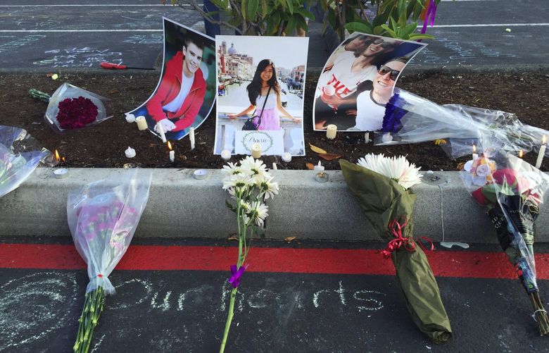 Students gathered on the parking lot of Kamiak High in Mukilteo to honor the slain students, remember them and hear choir members sing for them at a vigil
on Sat evening July 30, 2016. Photos of Jordan Ebner, Anna Bui and Jake Long were left