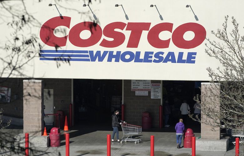 Shoppers walk into a Costco store, Wednesday, March 3, 2021, in Tacoma, Wash. Costco Wholesale Corp. reports earnings results, Thursday, March 4, 2021. (AP Photo/Ted S. Warren) WATW201 WATW201