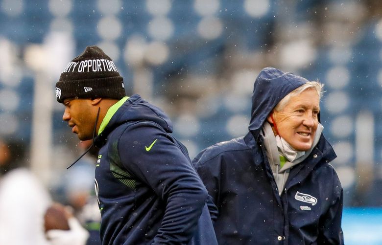 Lumen Field – Seattle Seahawks vs. Detroit Lions – 010222
Seattle Seahawks quarterback Russell Wilson and head coach Pete Carroll cross paths before the start of a game Sunday, Jan. 2, 2022, in Seattle, Wash. 219228