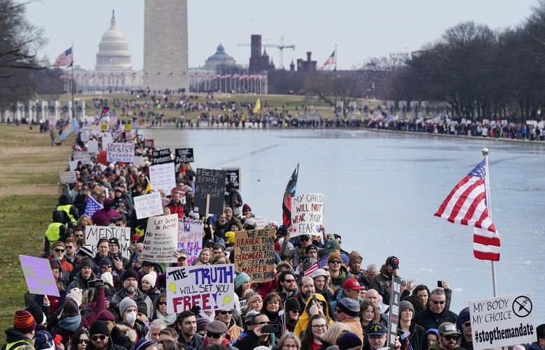 People march alongside the Lincoln Memorial Reflecting Pool before an anti-vaccine rally in Washington on Sunday, Jan. 23, 2022. (AP Photo/Patrick Semansky) DCPS101 DCPS101