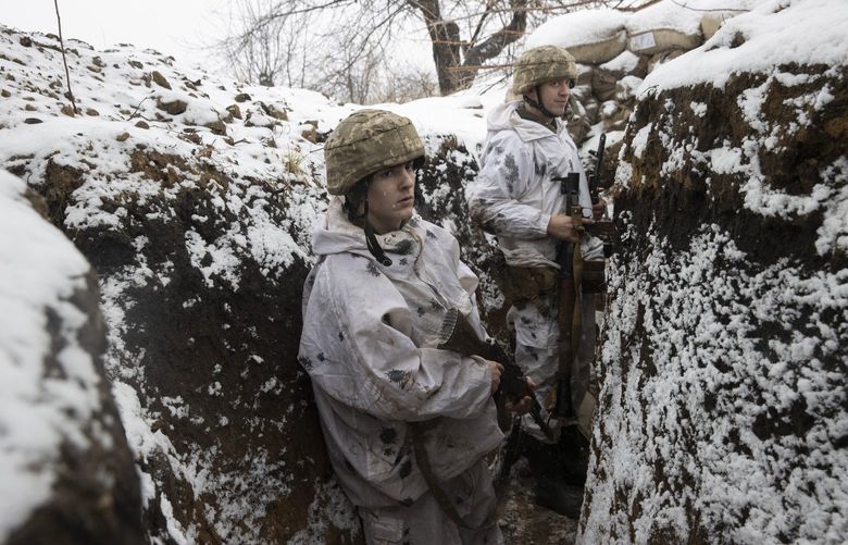 Members of the Ukrainian military in a front line trench at Katerynivka, in the Luhansk Oblast province of eastern Ukraine on Tuesday, Jan. 18, 2022. Russia annexed the Crimean Peninsula in 2014 and instigated a violent separatist uprising that effectively cleaved away two Ukrainian provinces. (Tyler Hicks/The New York Times) XNYT191 XNYT191