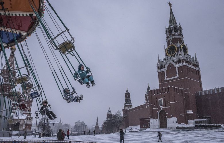 Youths ride a chair swing at Red Square in Moscow, Jan. 28, 2022. The boldest sanctions that the Biden administration is threatening to deter an invasion of Ukraine could roil the entire Russian economy â€” but also those of other nations. (Sergey Ponomarev/The New York Times)