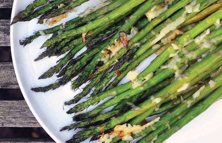 In “Good Enough: A Cookbook,” Leanne Brown offers ways to make life a little simpler in stressful times with quick, easy dishes like this Honeyed, Cheesy Asparagus. Credit: Courtesy Workman Publishing
(Original credit supplied by the publisher is: “Excerpted from Good Enough: A Cookbook by Leanne Brown. Workman Publishing Â© 2022”)