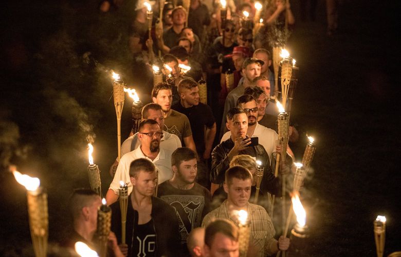 Several hundred white nationalists and white supremacists carrying torches and chanting, “White lives matter!” “You will not replace us!” and “Jews will not replace us!” march at a Unite the Right rally at the University of Virginia in Charlottesville on Aug. 11, 2017. MUST CREDIT: Photo for The Washington Post by Evelyn Hockstein