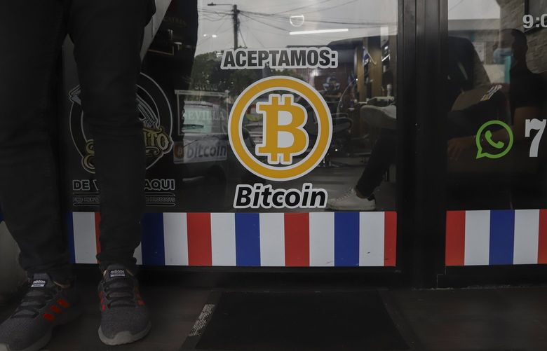 “We accept Bitcoin” is posted at a barber shop in Santa Tecla, El Salvador on Sept. 4, 2021. The IMF has urged the government of El Salvador on Tuesday, Jan. 25, 2022 to eliminate Bitcoin as legal tender. (AP Photo/Salvador Melendez, File) 