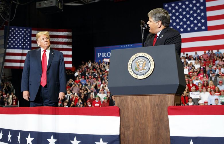 FILE – President Donald Trump listens Fox News’ Sean Hannity speak during a rally on Nov. 5, 2018, in Cape Girardeau, Mo. The House committee investigating the Jan. 6 U.S. Capitol insurrection has requested an interview and information from Hannity. (AP Photo/Carolyn Kaster, File) WX125 WX125