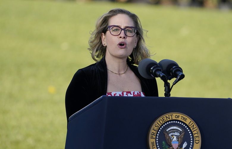 FILE – Sen. Kyrsten Sinema, D-Ariz., speaks before President Joe Biden signs the $1.2 trillion bipartisan infrastructure bill into law during a ceremony on the South Lawn of the White House in Washington, on Nov. 15, 2021. (AP Photo/Evan Vucci, File) WX205 WX205