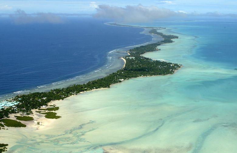 档案——在这张 2004 年 3 月 30 日的档案照片中，基里巴斯的塔拉瓦环礁以鸟瞰图的形式出现。 基里巴斯和其他几个太平洋小国是地球上最后避免任何病毒爆发的国家之一，这要归功于它们地处偏远和严格的边境管制。 但它们的防御似乎无法与高度传染性的 omicron 变体相媲美。 （美联社照片/理查德沃格尔，档案）