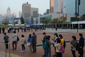 Residents line up against Hong Kong’s business district to get tested for the coronavirus at a temporary testing center for COVID-19 in Hong Kong Friday, Jan. 7, 2022. (AP Photo/Vincent Yu)
