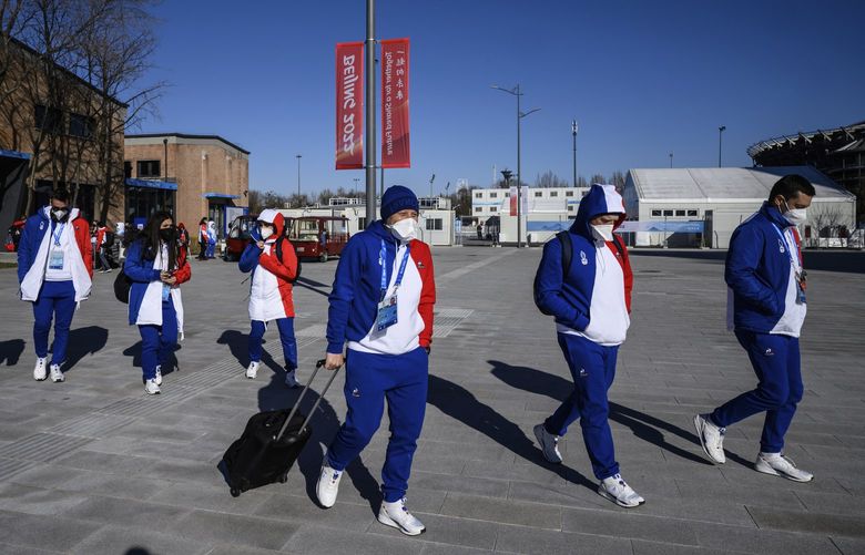 Members of Team France arrive at the Olympic Village ahead of the 2022 Winter Olympics, Tuesday, Feb. 1, 2022, in Beijing. (Anthony Wallace/Pool Photo via AP) OLYAG109 OLYAG109