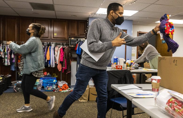 Housing stability services manager Tevin Medley fills a box for a participant of the Holiday Shop event at the LifeWire office in Bellevue on Wednesday, Dec. 8, 2021. LifeWire is an organization that offers support services from domestic violence survivors. During the holidays LifeWire has their Holiday Shop event through donation allow survivors to choose from an array of toys, warm clothing and household items. Due to the pandemic, the Holiday Shop event has gone virtual. 219017