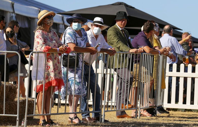 Racegoers look on from 100-person-maximum pods due to COVID-19 restrictions during Wellington Cup Day at Trentham, on Jan. 29, 2022, in Wellington, New Zealand. (Hagen Hopkins/Getty Images/TNS) 39163723W 39163723W