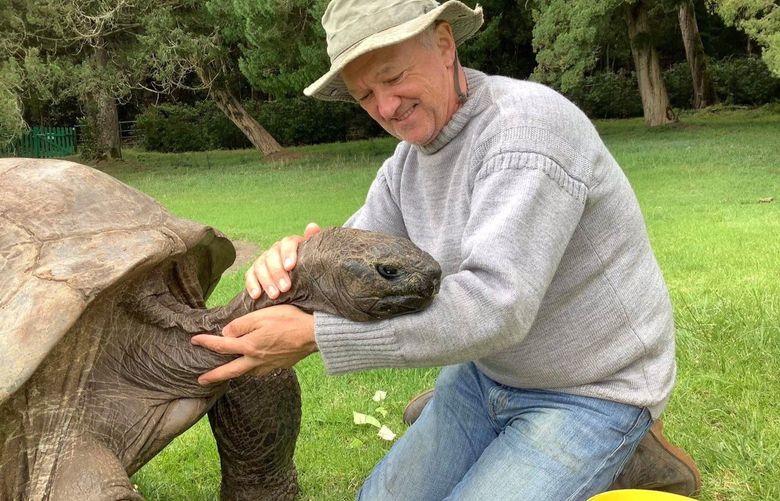 Jonathan the tortoise, 190, and his caretaker, Joe Hollins, 64, on St. Helena island. MUST CREDIT: Tina Lucy
