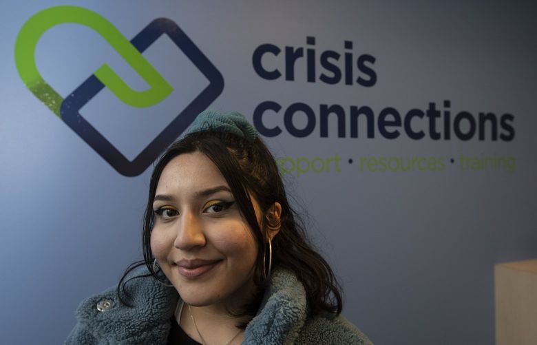 Clarissa Perez, a 20 year old Teen Link volunteer, helps other young people navigate crisis and mental health concerns through a teen hotline, Wednesday, Feb. 2, 2022 in Renton. Perez helps others on the hotline via text from home but was photographed at the Crisis Connections offices where Teen Link volunteers have phones and computers for texting. 219480