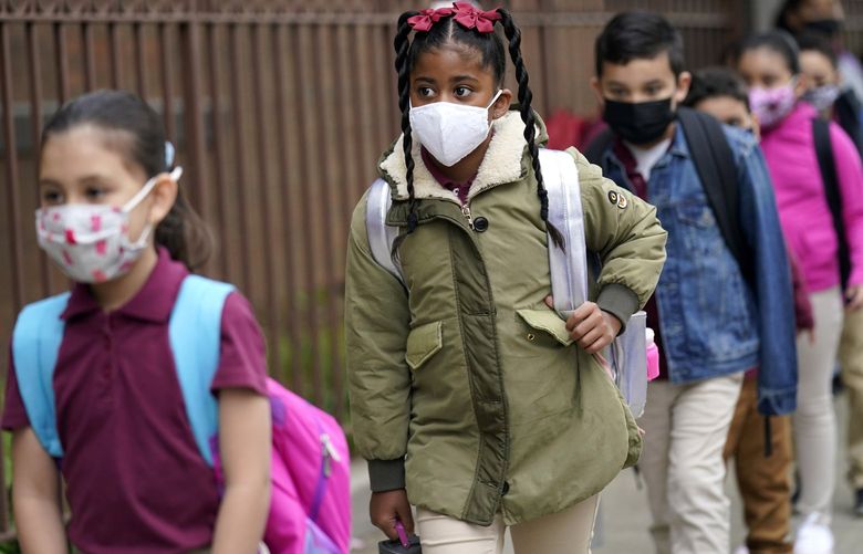 FILE – Students line up to enter Christa McAuliffe School in Jersey City, N.J., April 29, 2021. New Jersey Gov. Phil Murphy will end a statewide mask mandate to protect against COVID-19 in schools and child care centers, his office said Monday, Feb 7, 2022. (AP Photo/Seth Wenig, File) RDNY102 RDNY102