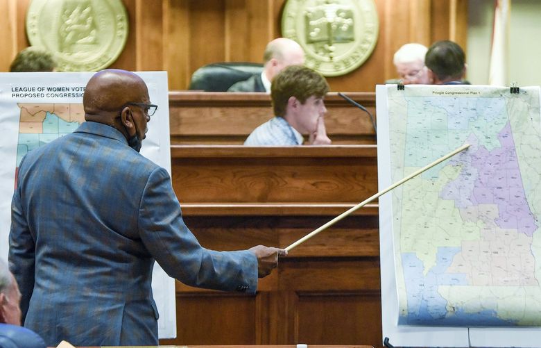 FILE – Sen. Rodger Smitherman compares U.S. Representative district maps during the special session on redistricting at the Alabama Statehouse in Montgomery, Ala., on Nov. 3, 2021. The Supreme Court has put on hold a lower court ruling that Alabama must draw new congressional districts before the 2022 elections, boosting Republican chances to hold six of the stateâ€™s seven seats in the House of Representatives.  (Mickey Welsh/The Montgomery Advertiser via AP, File) ALMON201 ALMON201