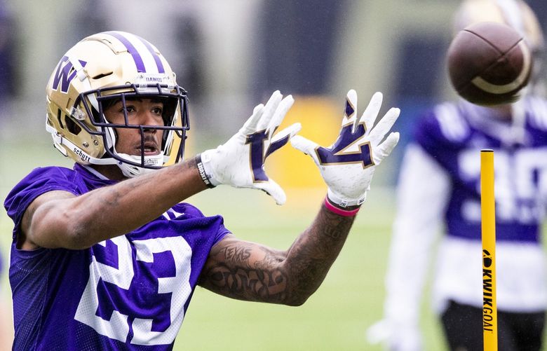 Wide receiver Ja’Lynn Polk (23) catches the ball during a drill at spring practice at the east practice field on Wednesday, April 7, 2021.