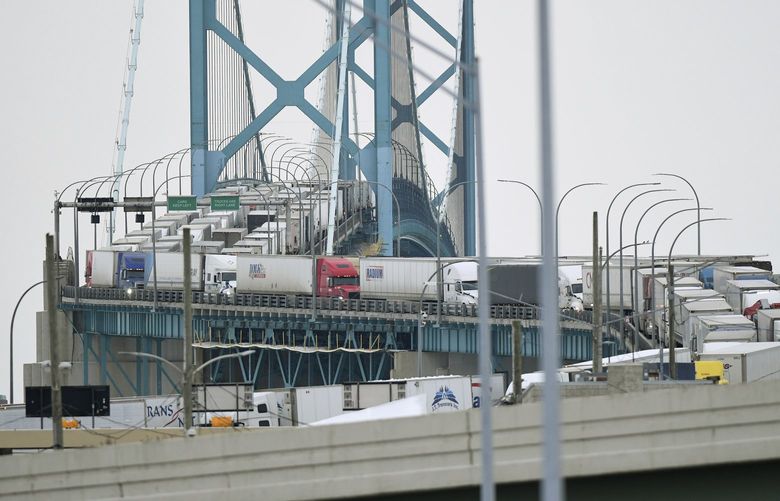 Trucks are backed up heading to and from Canada on the Ambassador Bridge, due to protests on the Windsor side, in Detroit on Monday, Feb. 7, 2022. Canada’s public safety minister said Monday that U.S. officials should stay out of his country’s domestic affairs, joining other Canadian leaders in pushing back against prominent Republicans who offered support for the protests of COVID-19 restrictions that have besieged downtown Ottawa for more than a week. (Daniel Mears /Detroit News via AP) MIDTN102 MIDTN102