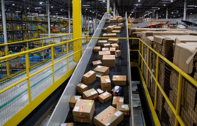 Packages move along a conveyor at an Amazon fulfillment center on Cyber Monday in Robbinsville, New Jersey. Photographer: Michael Nagle/Bloomberg