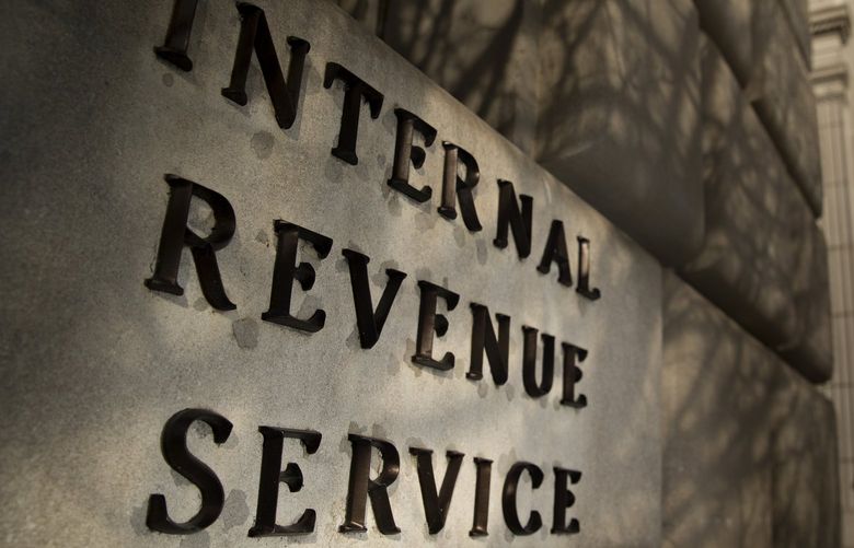 A woman walks out of the Internal Revenue Service (IRS) headquarters building in Washington, D.C., U.S., on Wednesday, Feb. 17, 2016. Taxpayers have until Monday, April 18 to file their 2015 tax returns and pay any tax owed. Photographer: Andrew Harrer/Bloomberg