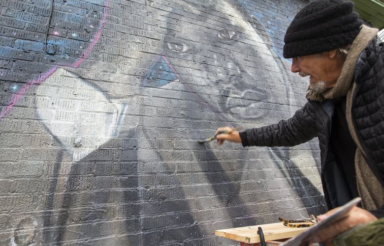 James Crespinel, whose original Martin Luther King, Jr. mural he painted 26 years ago in the Central District was defaced recently, has returned to Seattle from his home in Mexico to repair the artwork, Thursday, Feb. 10, 2022. Crespinel said the Mariners and Alaska Air joined forces to get him a plane ticket, while a GoFundMe “MLK Mural Restoration” has already raised $18,000. 219591