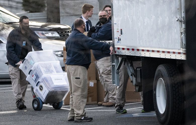 Workers load boxes of newspapers and other items into a truck outside the Eisenhower Executive Office Building in the White House complex on Jan. 14, 2021. MUST CREDIT: Washington Post photo by Jabin Botsford