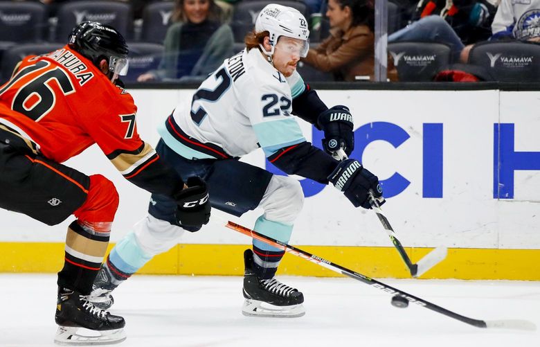 Seattle Kraken center Mason Appleton, right, takes a shot under pressure from Anaheim Ducks defenseman Josh Mahura during the first period of an NHL hockey game in Anaheim, Calif., Friday, Feb. 11, 2022. (AP Photo/Alex Gallardo) ANA105