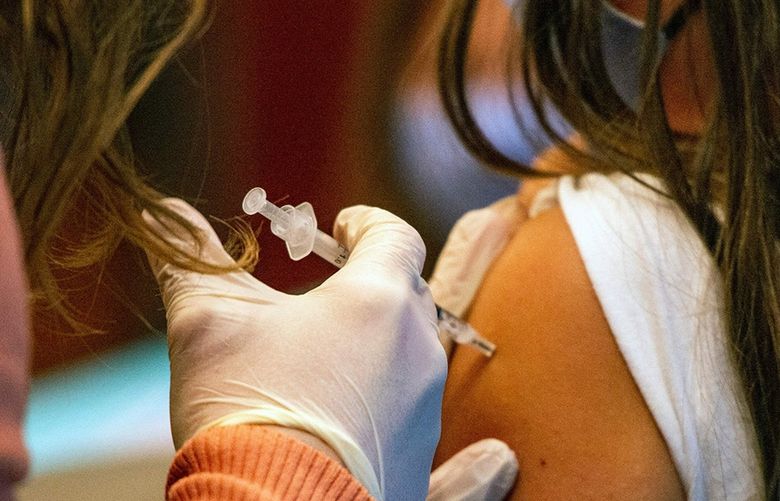 A 5-year-old child receives the Pfizer-BioNTech COVID-19 vaccine for kids ages 5-11 at Hartford Hospital in Hartford, Connecticut, on Nov. 2, 2021. (Joseph Prezioso/AFP via Getty Images/TNS) 39889947W 39889947W