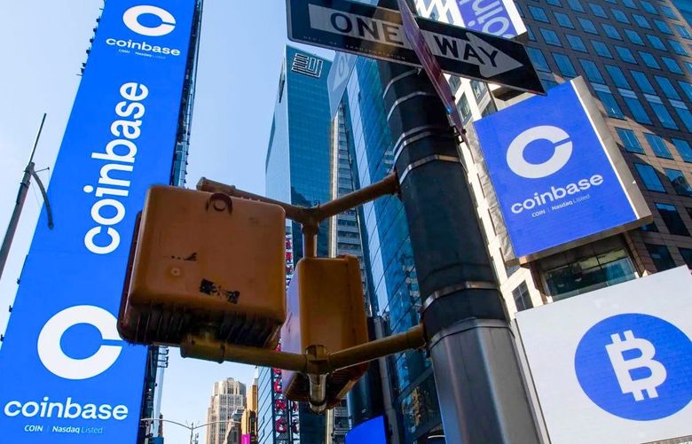 Monitors display Coinbase signage during the company’s initial public offering at the Nasdaq MarketSite in New York, April 14, 2021. Coinbase Global Inc., the largest U.S. cryptocurrency exchange, debuted through a direct listing, an alternative to a traditional initial public offering.