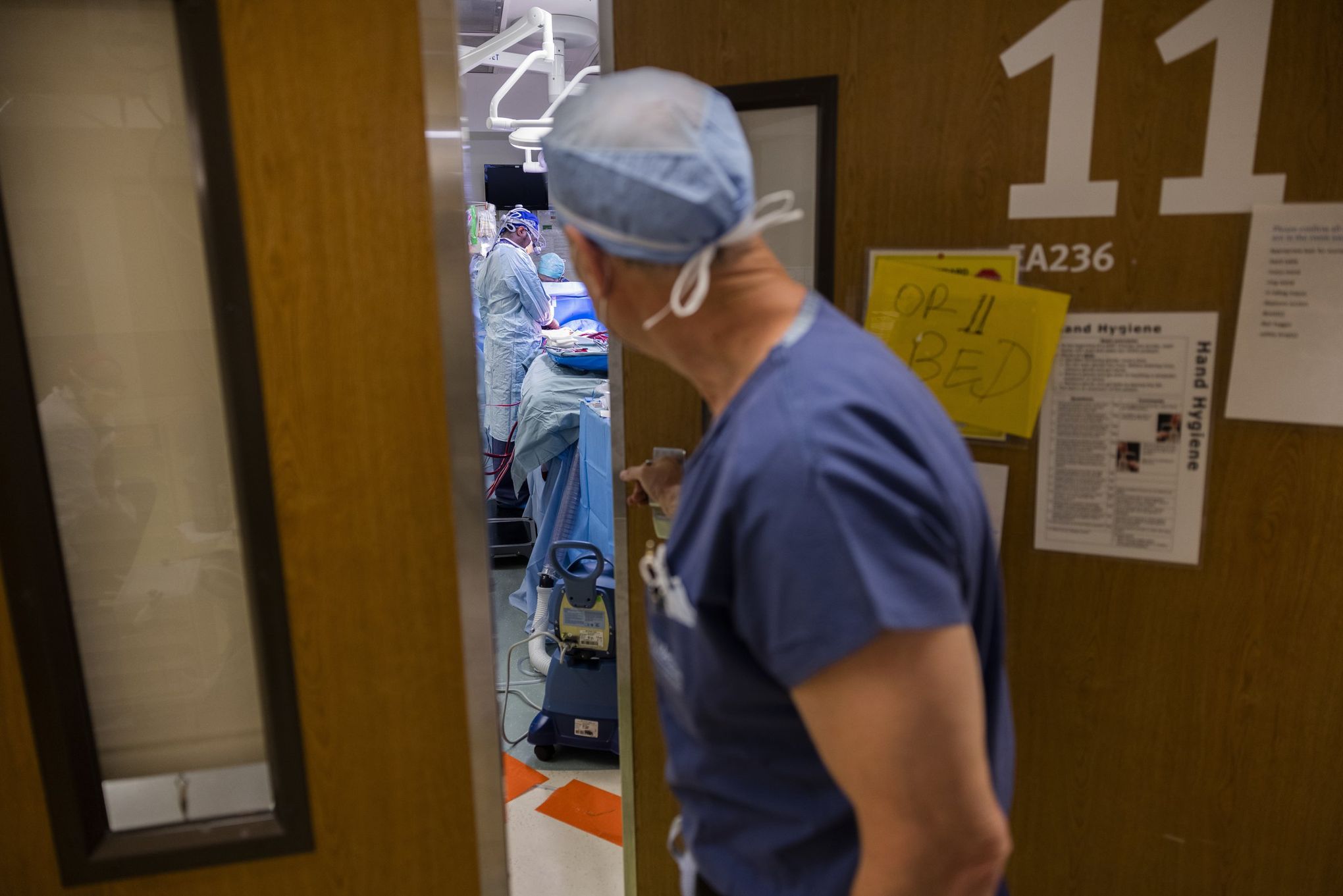UW Medicine surgery chair Dr. Doug Wood peeks into an OR in the main operating suite at UW Medical Center