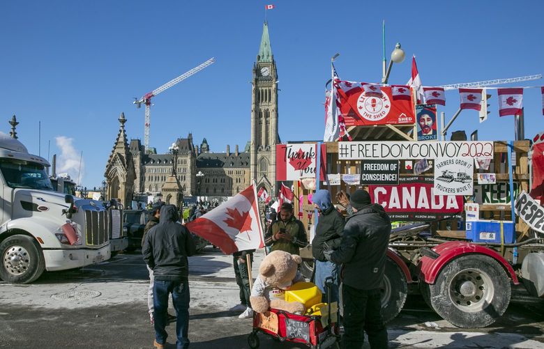 Drivers have parked their trucks blocking lanes of traffic to protest against pandemic restrictions in Ottawa, Ontario, on Monday, Feb. 14, 2022. (AP Photo/Ted Shaffrey) RPTS105 RPTS105