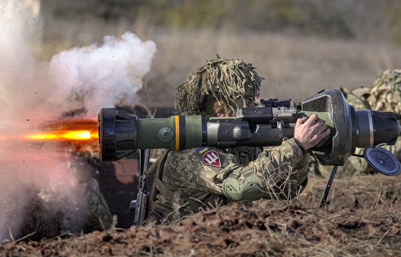 A Ukrainian serviceman fires an NLAW anti-tank weapon during an exercise in the Joint Forces Operation, in the Donetsk region, eastern Ukraine, Tuesday, Feb. 15, 2022. While the U.S. warns that Russia could invade Ukraine any day, the drumbeat of war is all but unheard in Moscow, where pundits and ordinary people alike don’t expect President Vladimir Putin to launch an attack on its ex-Soviet neighbor. (AP Photo/Vadim Ghirda) XVG101 XVG101