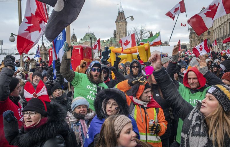 Protesters in downtown Ottawa, Ontario, Feb. 12, 2022. Amid progress at a border bridge, Ottawa remained frozen by an anti-government protest, but truckers were said to be weighing pulling out of part of the Canadian capital. (Brett Gundlock/The New York Times) XNYT289 XNYT289