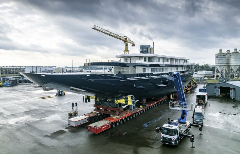View of a yacht, reportedly being built for Amazon founder Jeff Bezos, on the wharf in Zwijndrecht, near Rotterdam, Netherlands, Wednesday, Oct. 21, 2021. A plan to dismantle a historic bridge in the heart of Dutch port city Rotterdam so that the huge yacht can get to the North Sea is unlikely to be plain sailing. Reports this week that the city had already agreed to take apart the recently restored Koningshaven Bridge, known locally as De Hef sparked anger in the city, with one Facebook group set up calling for people to pelt the multimillion dollar yacht with rotten eggs. (AP Photo/Guy Fleury) PDJ804 PDJ804
