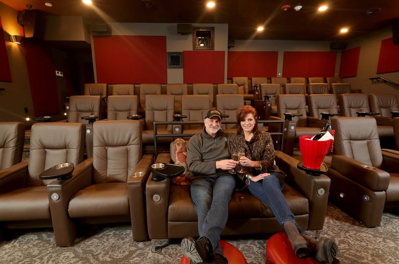 Mark and Katie Stern relax in the front row of The Big Picture movie theater in Issaquah. Their new theater replaces the one they operated in Belltown. (Greg Gilbert / The Seattle Times)